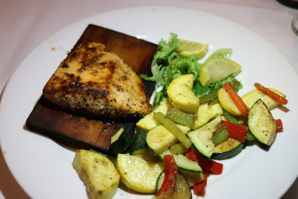 Cedar Plank Salmon with Brown sugar crusted with garlic and smoked sea salt, served with sautéed vegetables.