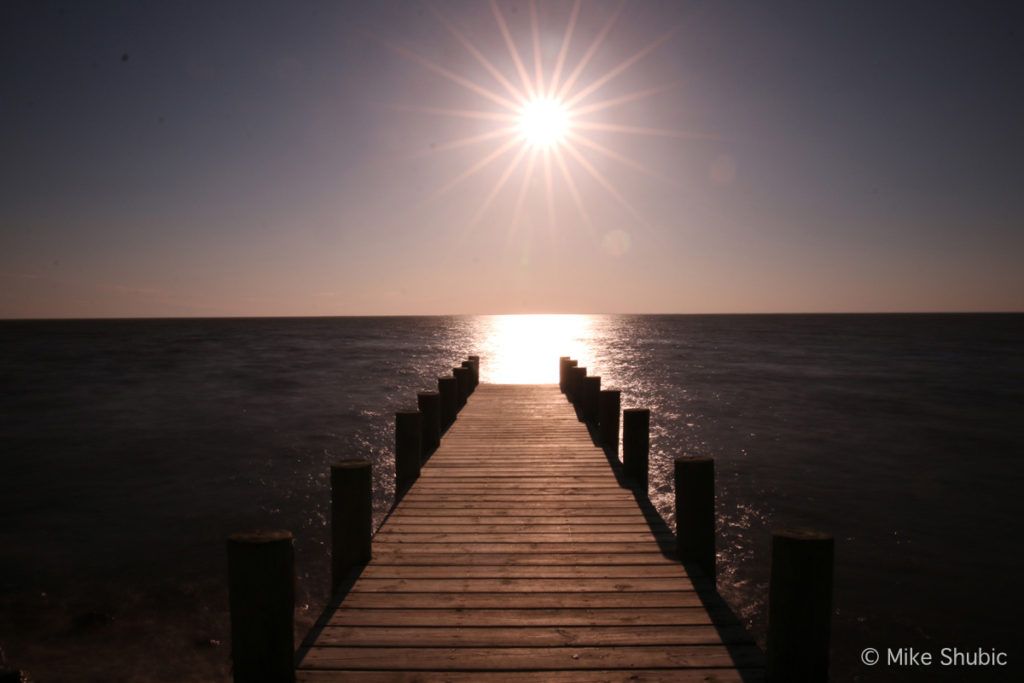 Boat dock with sunset in Point Clear, AL by MikesRoadTrip.com