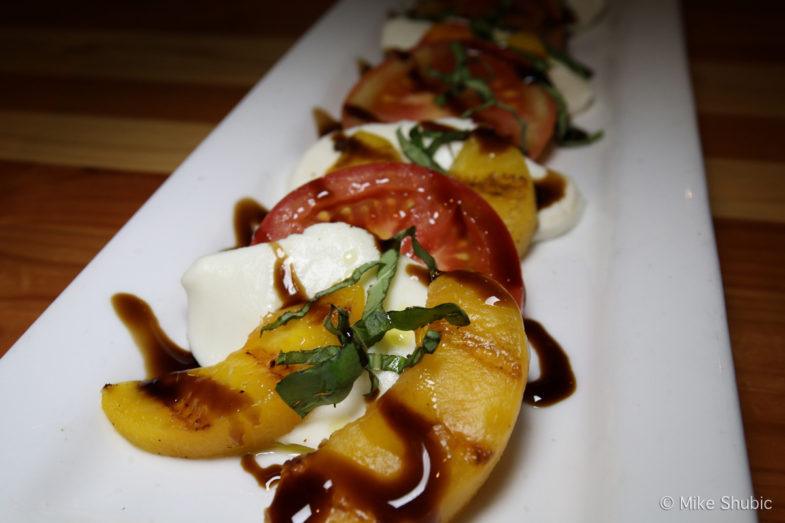 Tavern Caprese - Grilled peaches, tomato, mozzarella, basil and balsamic syrup.