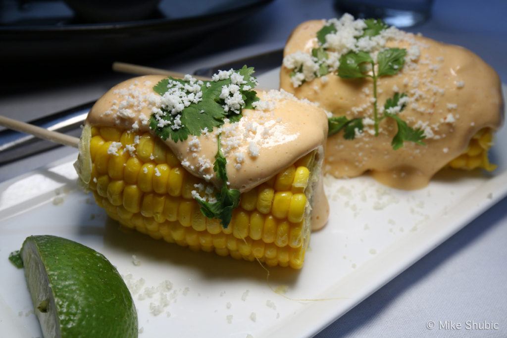 Grilled Street Corn - Skewered corn, butter, chila paprika, aji rocoto, cilantro & cotija.