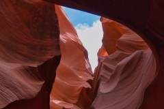 Antelope-Canyon-with-a-spot-of-blue-and-white-sky-vertical