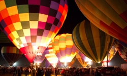 Hot air balloons glowing at night