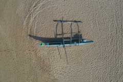 Outrigger-on-beach-drone-straight-down