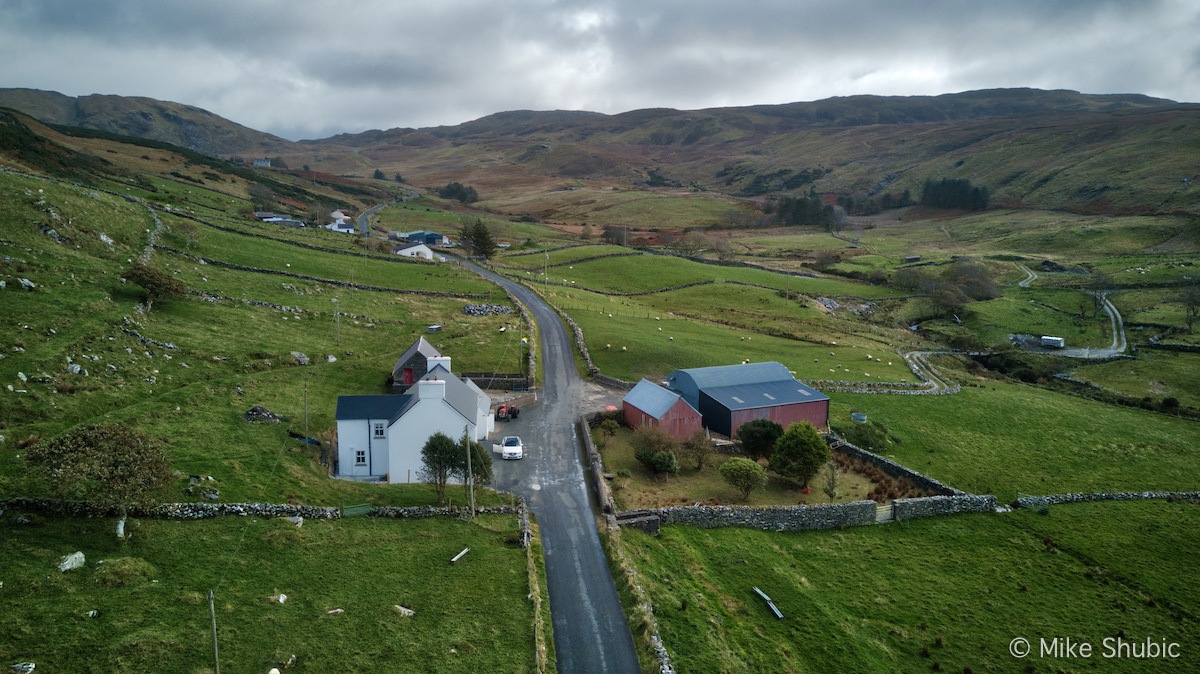 Road running through a farm by MikesRoadTrip.com