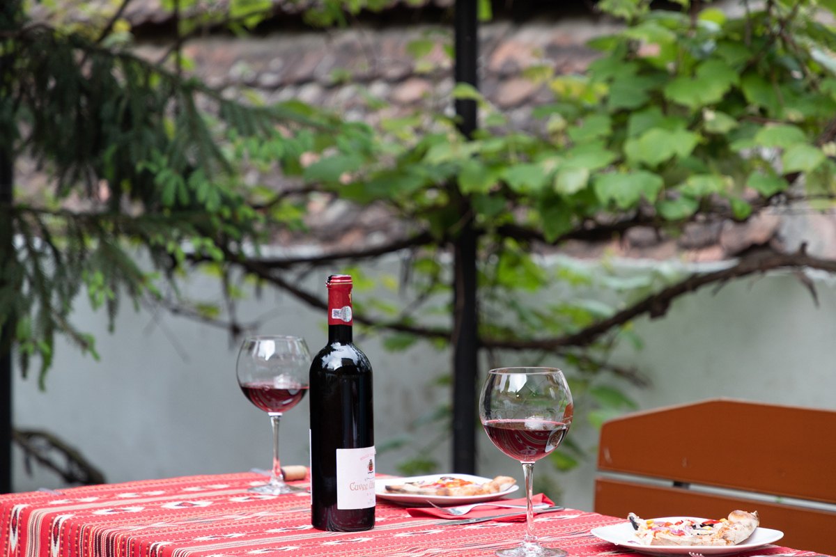 Bottle of wine in the courtyard of Taschler Haus Boutique Inn in Sighisoara