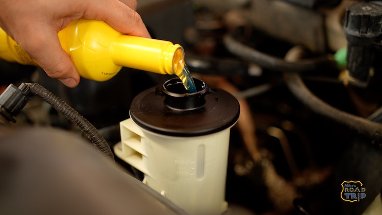 Checking your fluids is one of the essential road trip car maintenance tips.