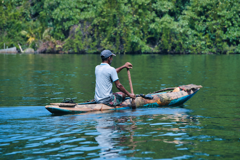 Fisherman in wooden kayak in Bentota Sri Lanka - Photo by Mike Shubic