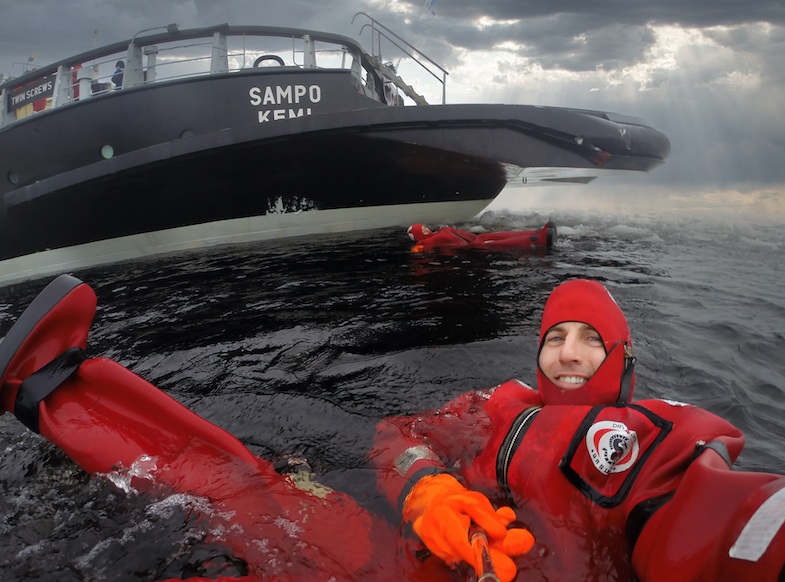 Mike swimming with icebergs on an icebreaker cruise