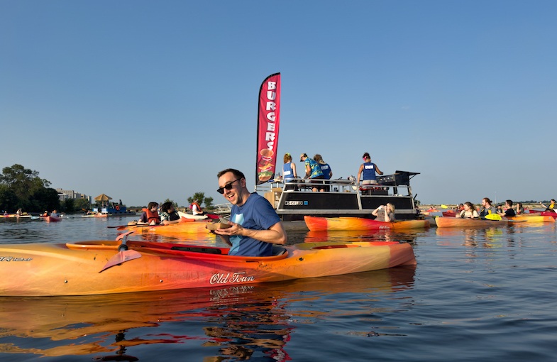 Chris Mitchell with Traveling Mitch having a burger while kayaking in Madison